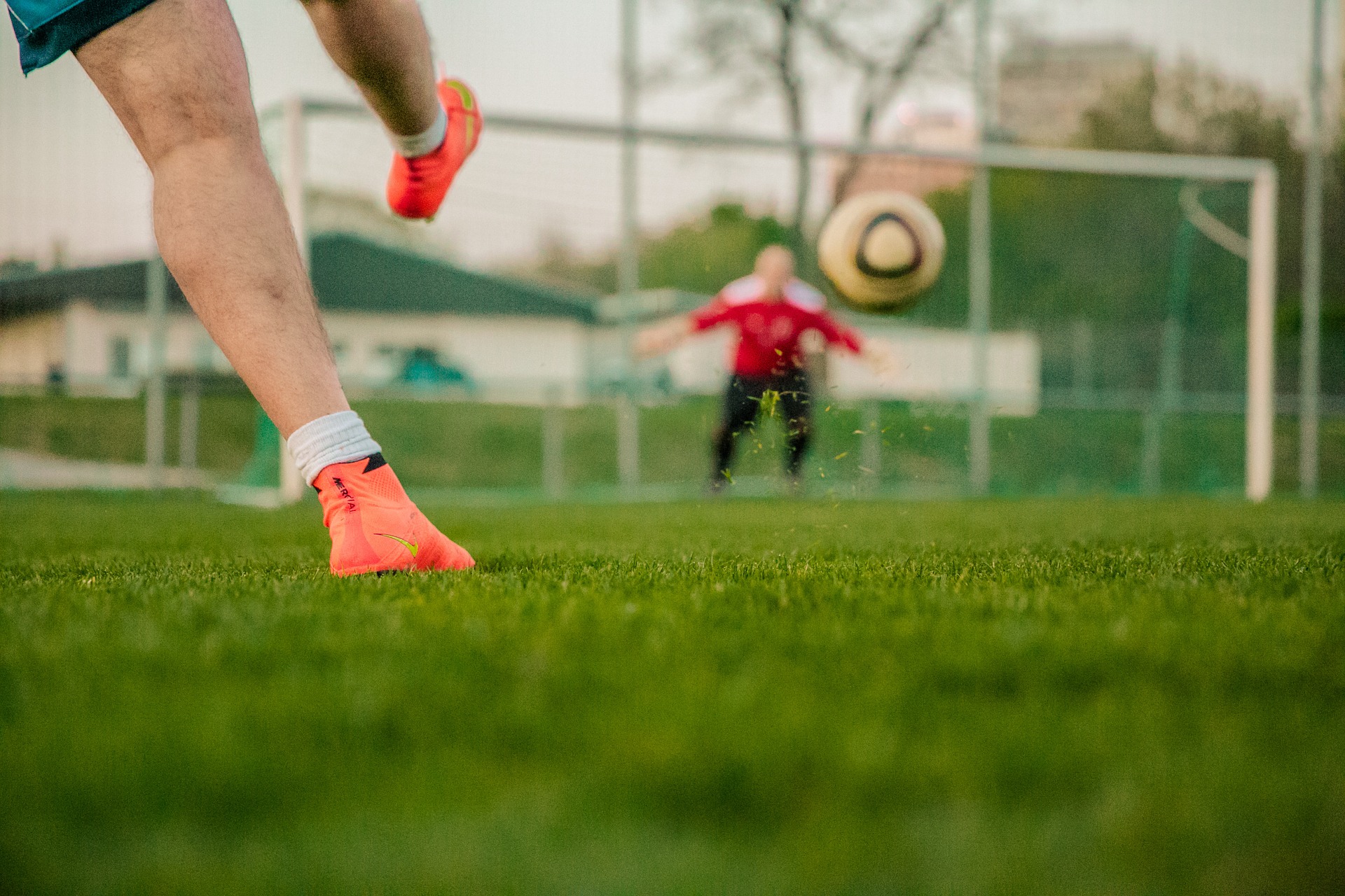 Kicking ball on football pitch