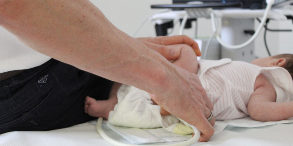 Baby receiving hip screening