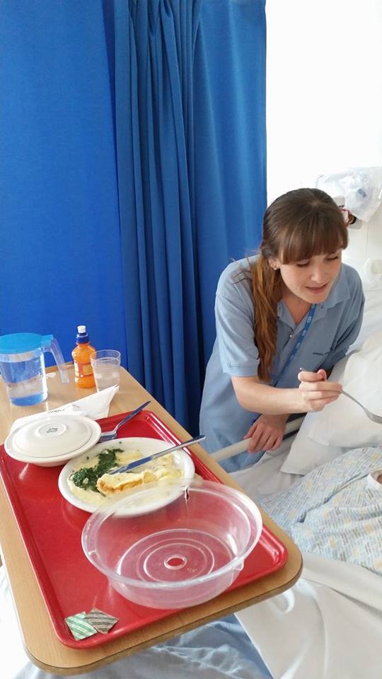 A mealtime assistant helping a patient