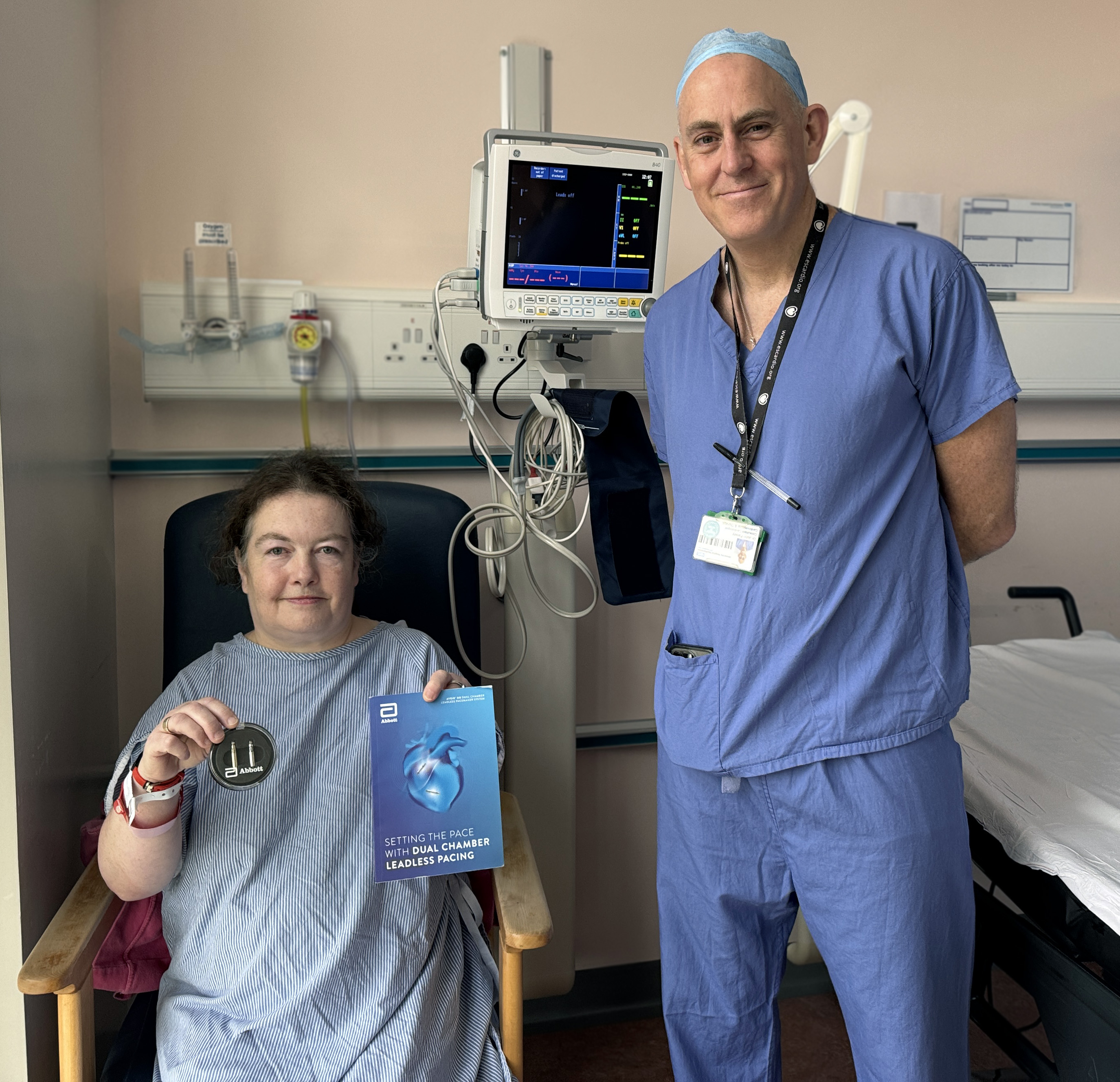 Karen Cooper holds up device sitting alongside Dr John Paisey, consultant cardiologist at UHS