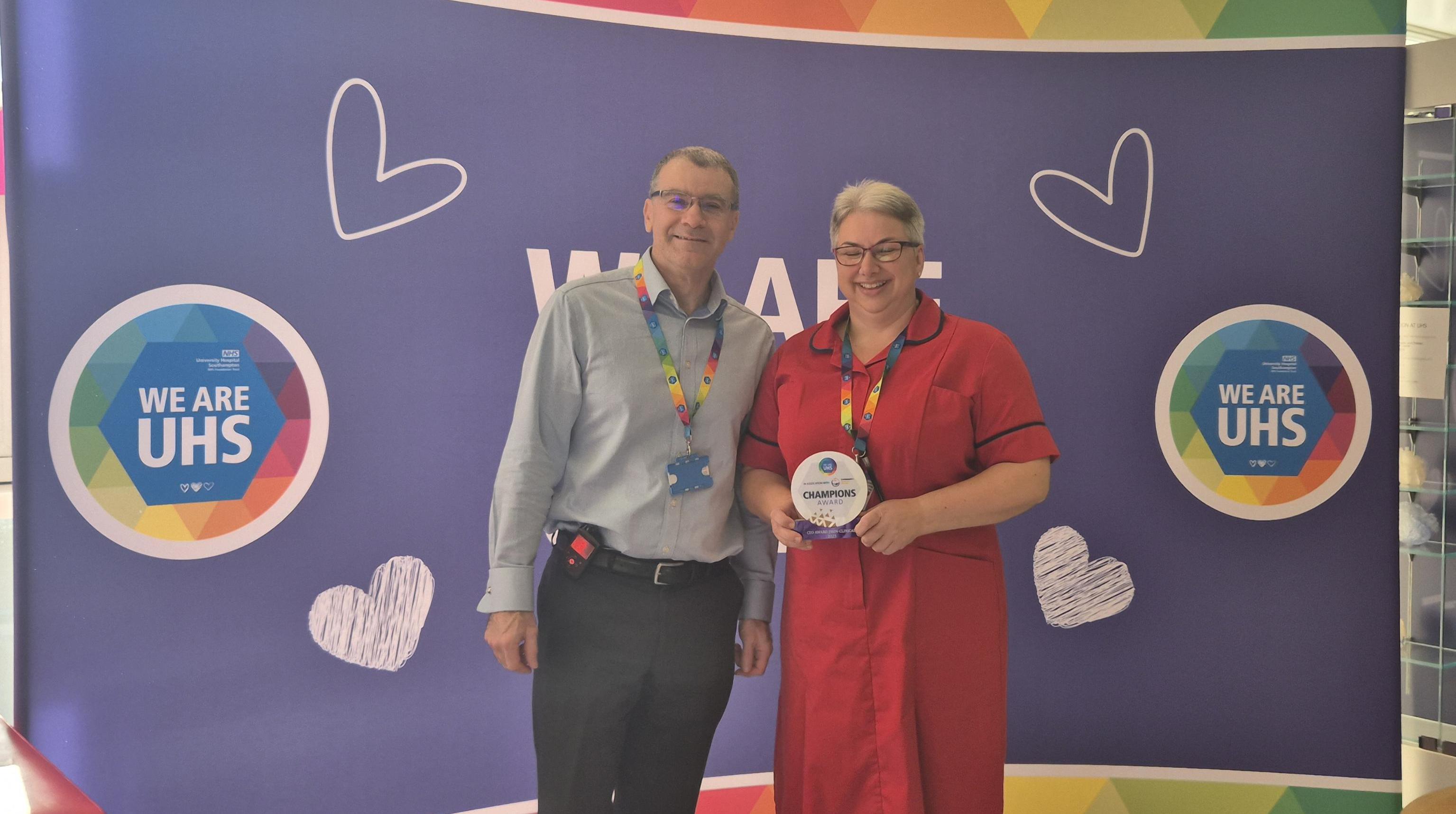 Sarah Swanton standing with CEO David French