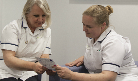 Staff reading patient information