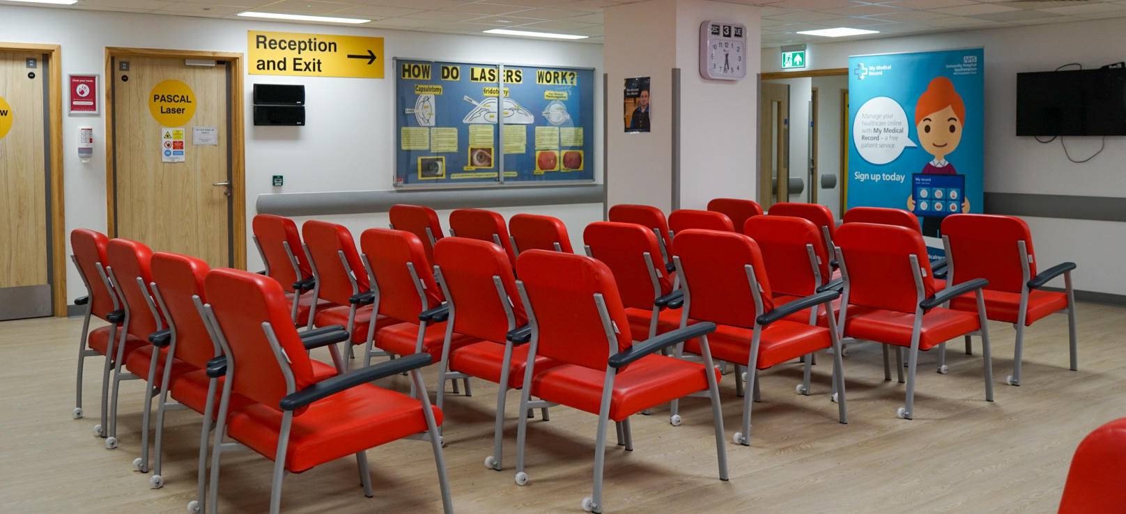 Rows of red chairs in the waiting room