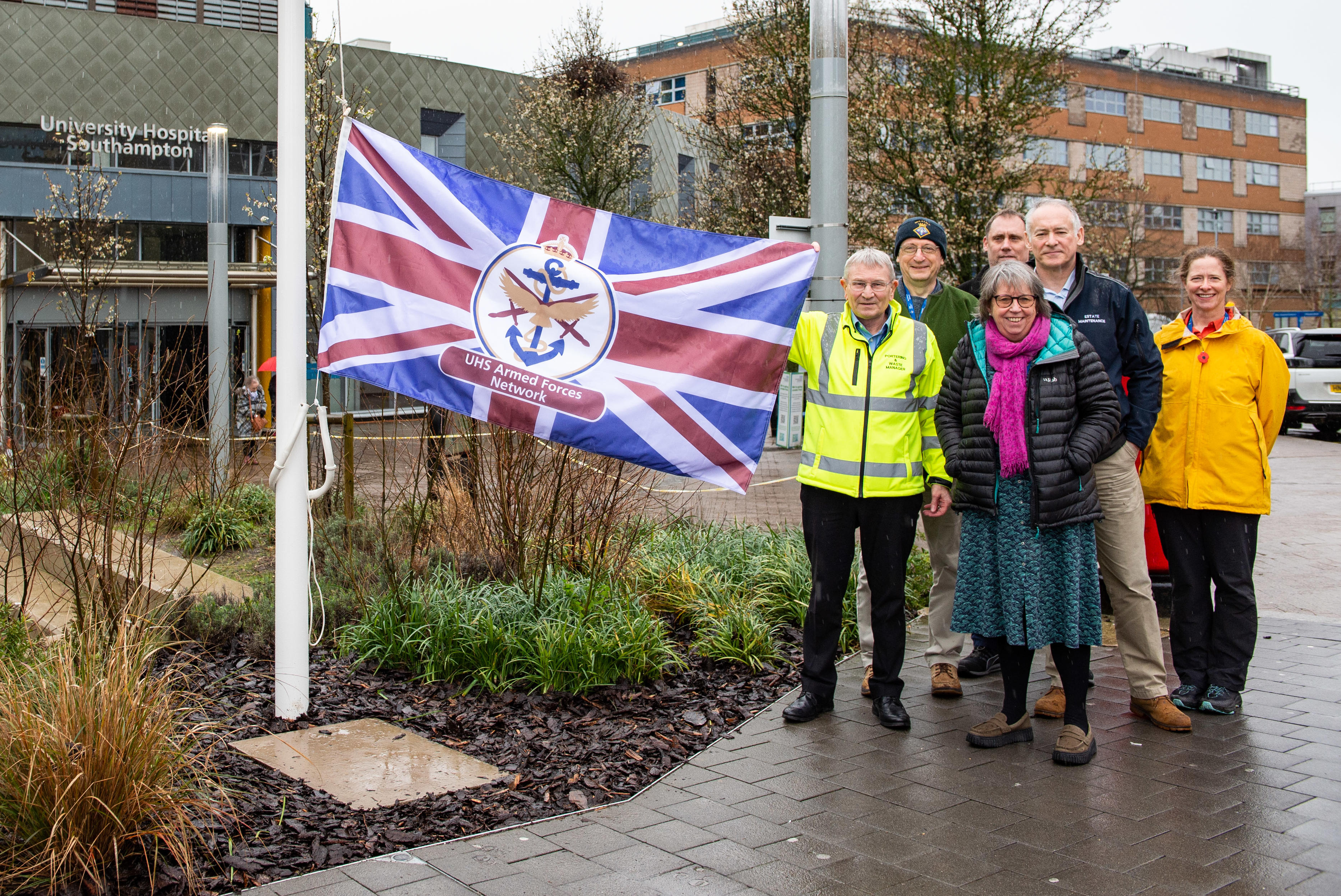 People stood by the UHS Armed Forces Network flag