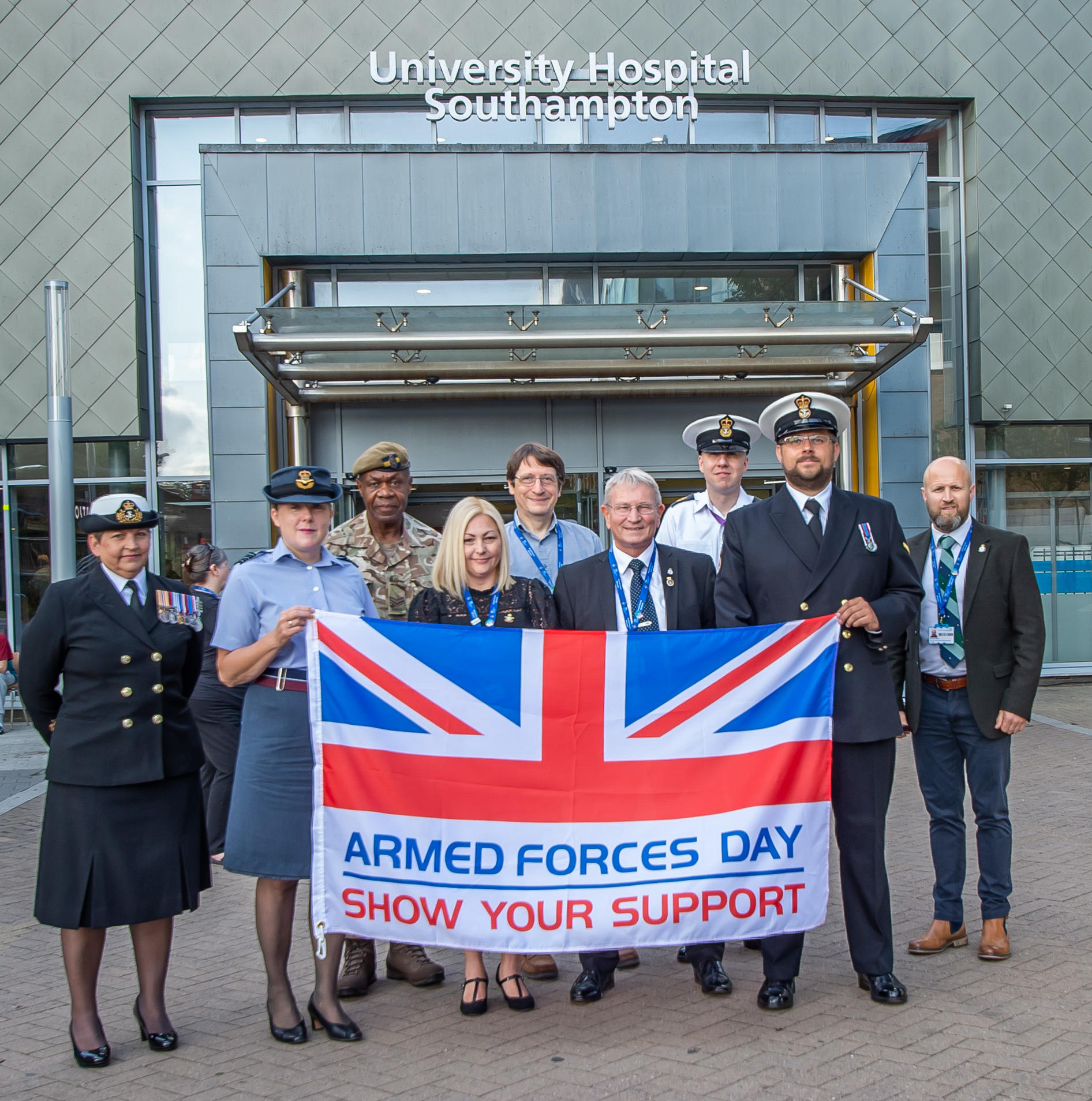 Group of people holding a flag for Armed Forces Day