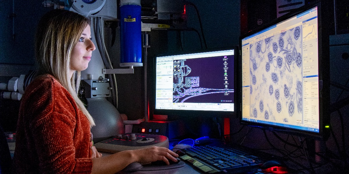 Clinical scientist, Regan, viewing samples through specialist equipment