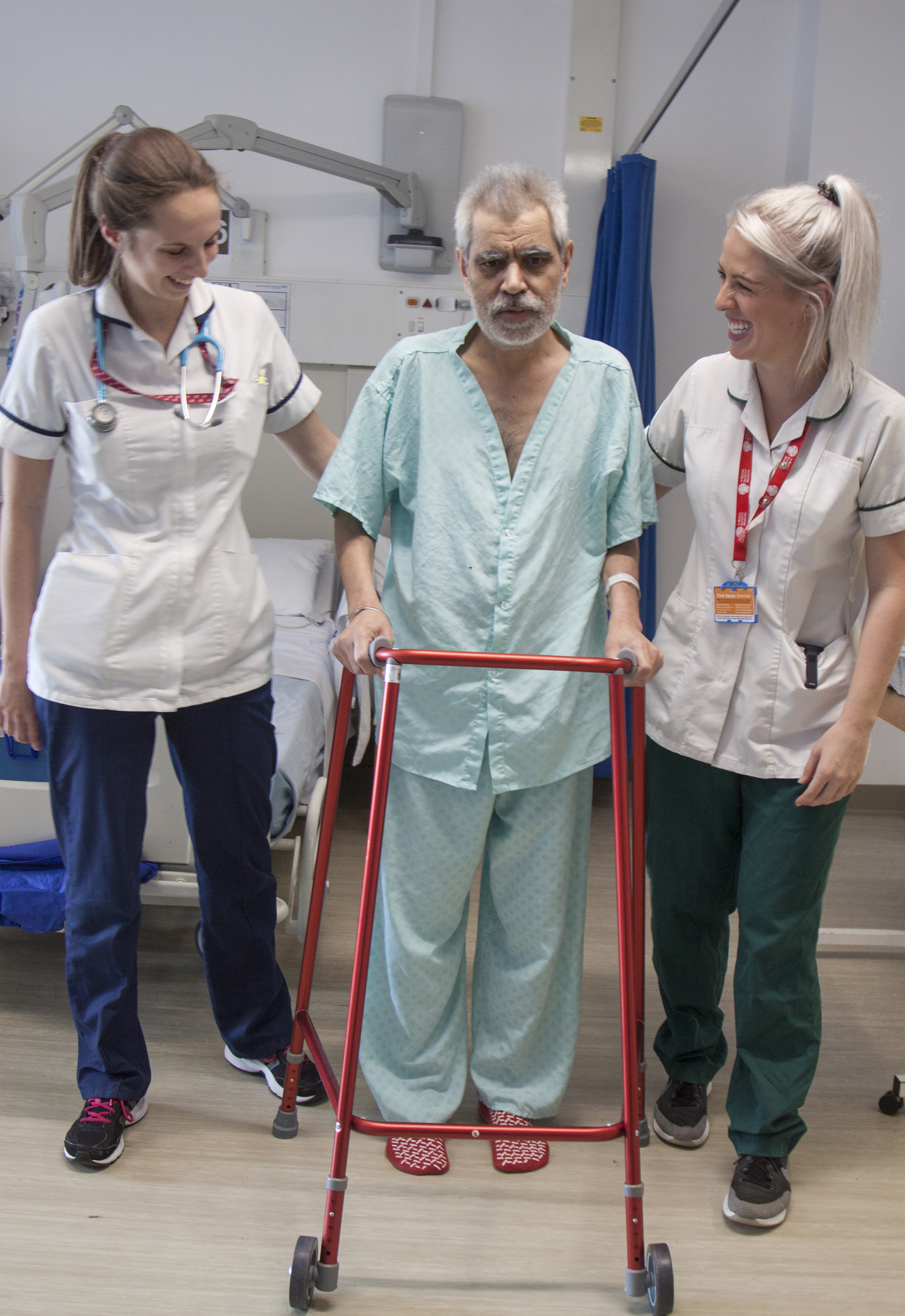 Therapists with patient using walking frame